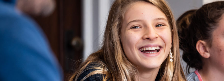 A teenage girl smiles at church