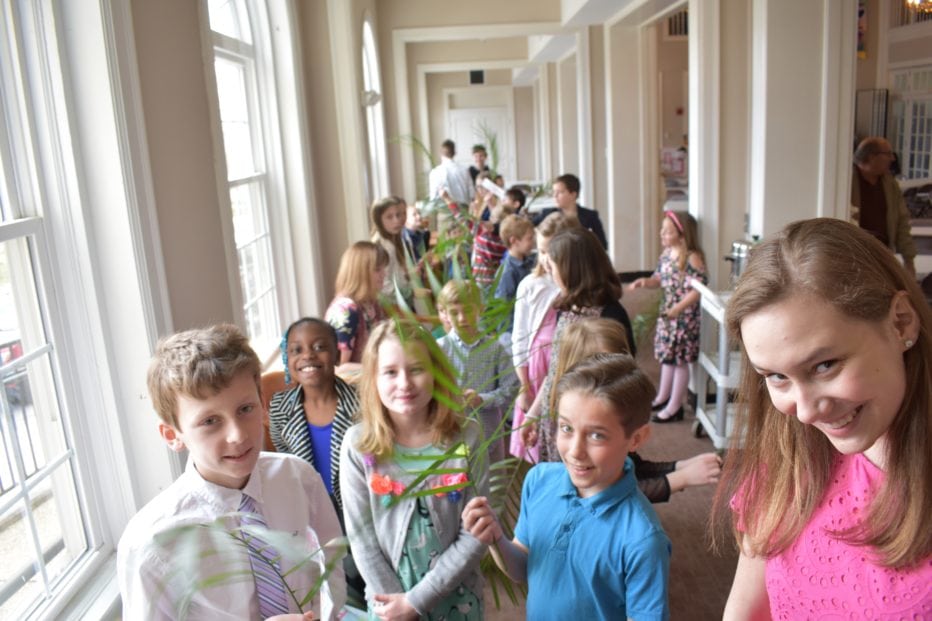 Children hold palms as they line up to parade through the sanctuary on Palm Sunday