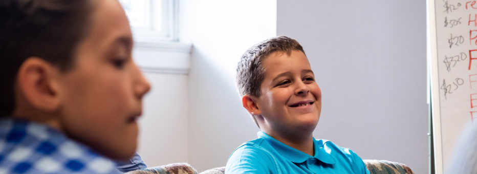 A pre-teen boy smiles during Sunday School.