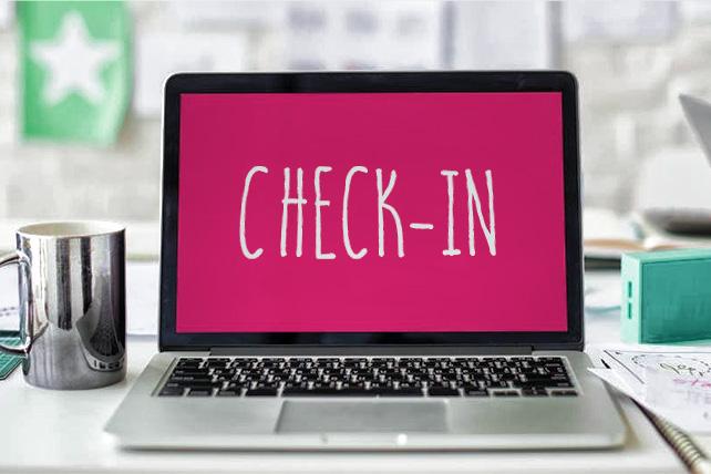 A laptop displaying the words "Check-In"