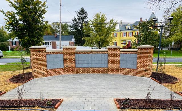 CPC's columbarium is a half-wall made of bricks and set with gray square niches with a patio in front.