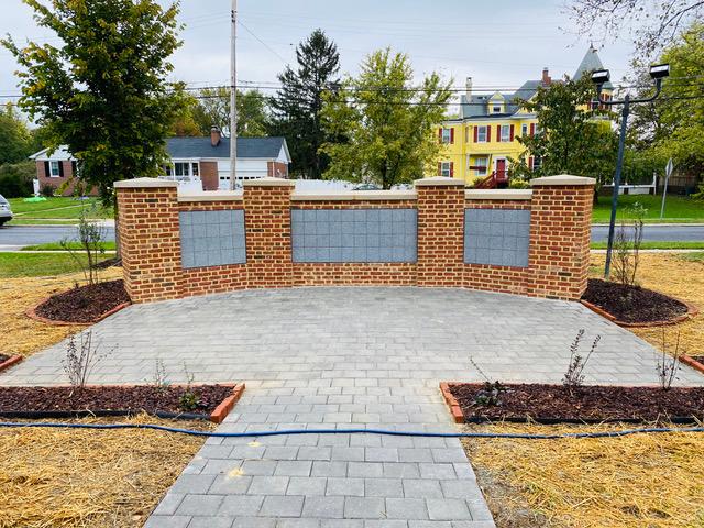 CPC's columbarium is a half-wall made of bricks and set with gray square niches with a patio in front.
