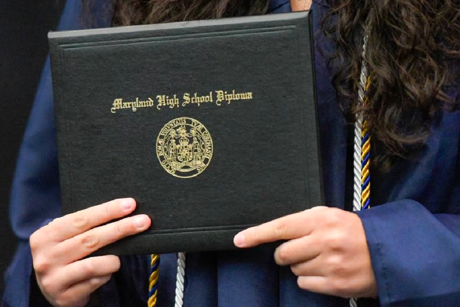 Student holding Baltimore high school diploma