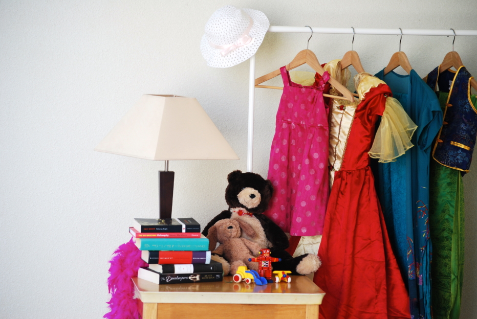 Clothing rack with toys nearby