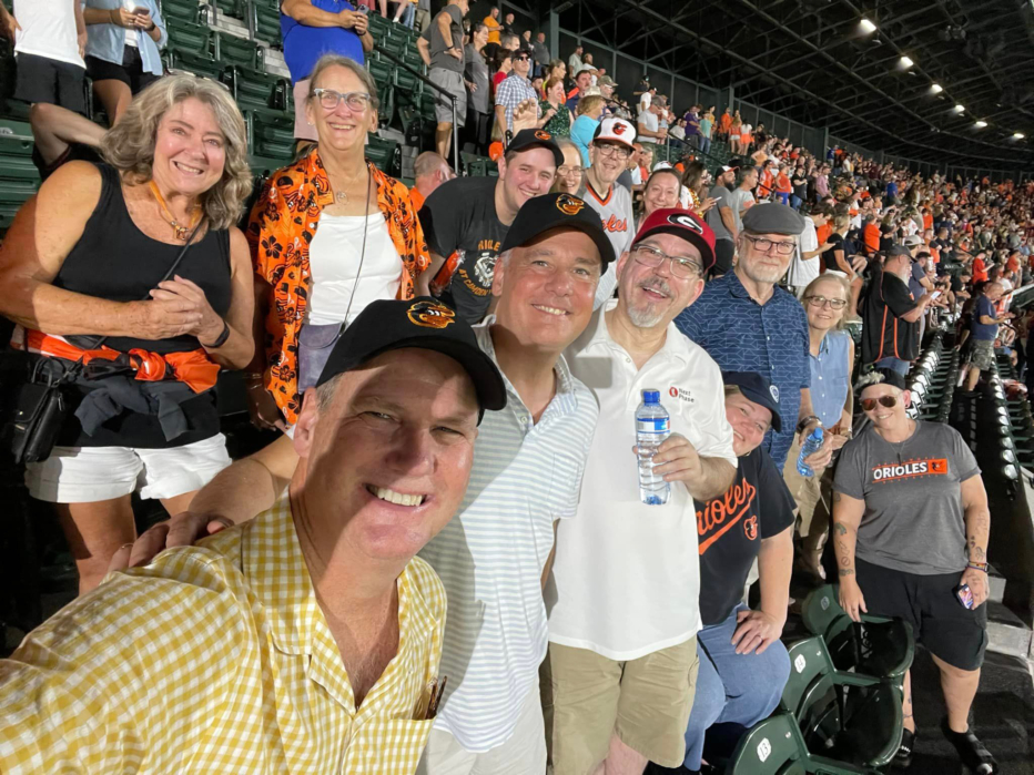 Group of members showing Orioles spirit at Camden Yards
